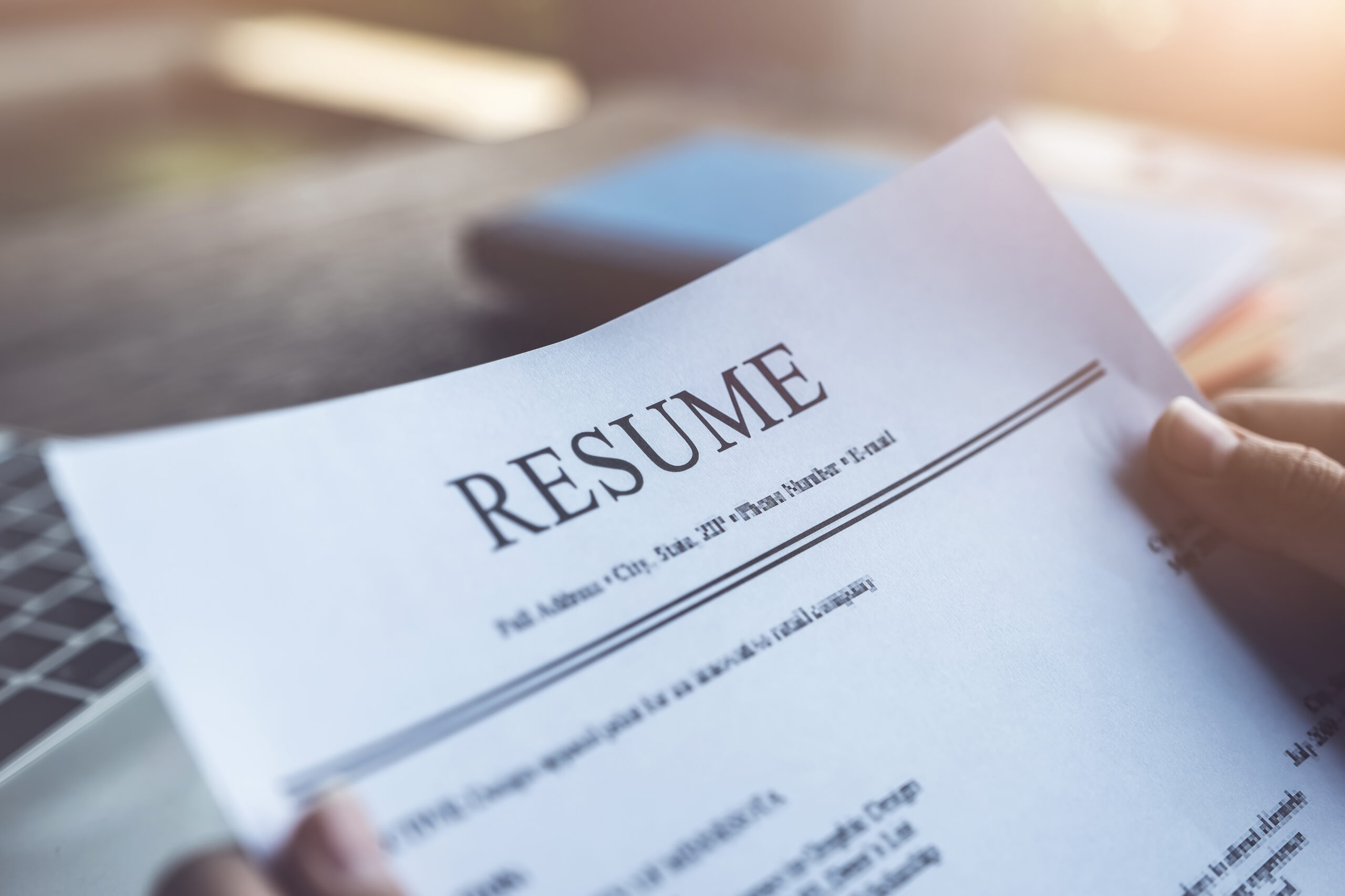 New graduate student holding resume application with pen coffee